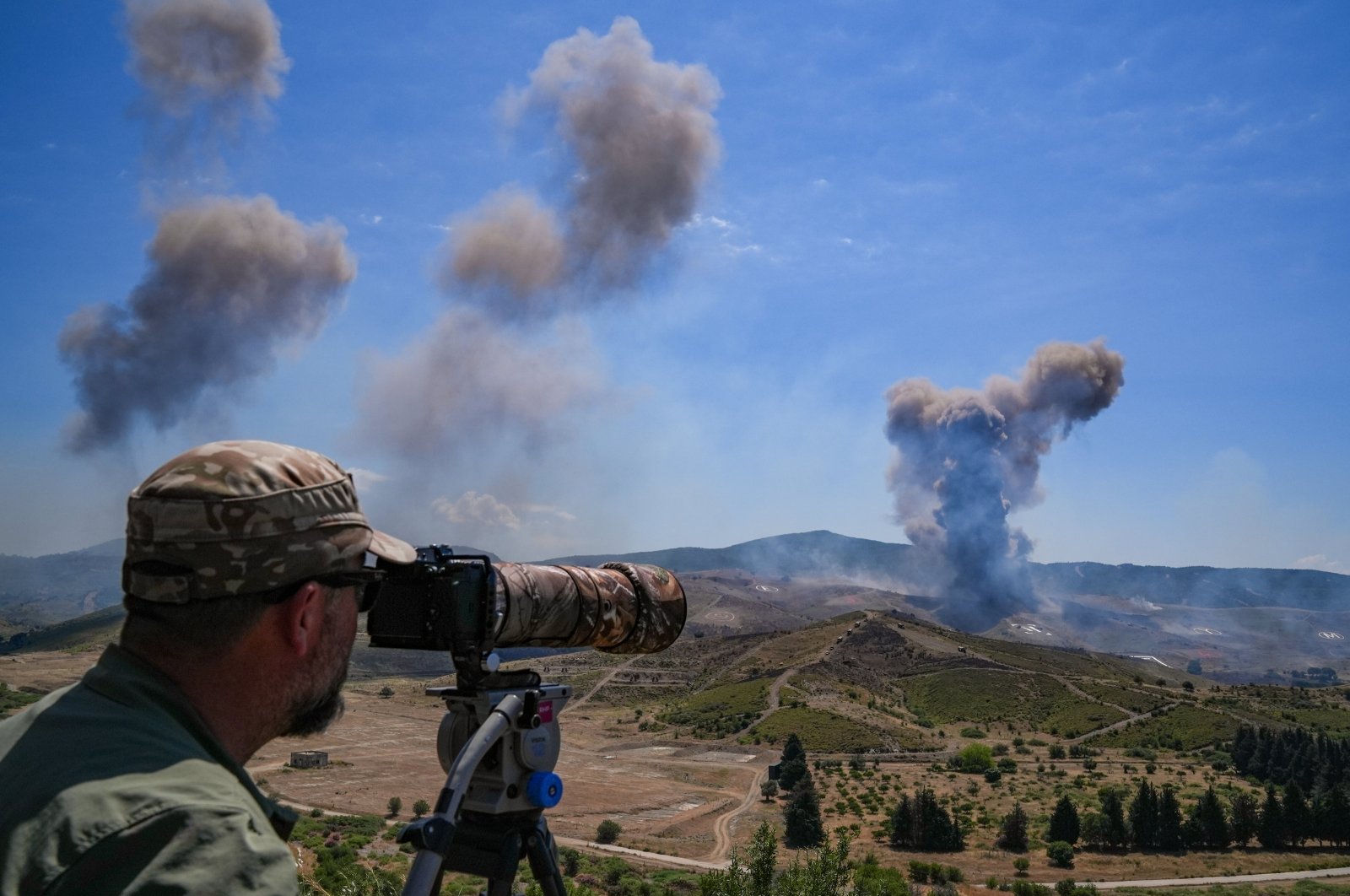 A trooper looks over at explosions in the distance as Turkish Armed Forces (TSK) conduct the Efes-2024 military drill in western Izmir province, Türkiye, May 30, 2024. (AA Photo)