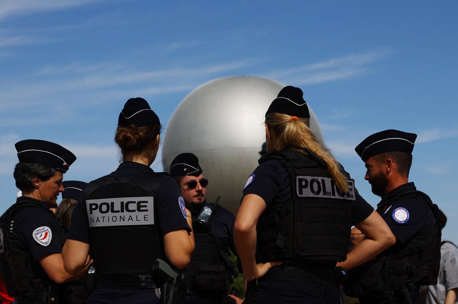 Police officers are seen near the Olympic cauldron during the Olympics, Paris, France, July 28, 2024. (Reuters Photo) 