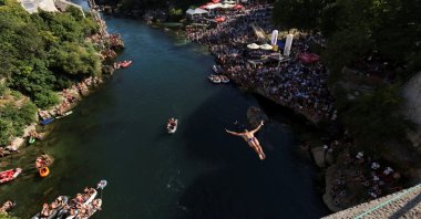 A high diver jumps from the arch of the Old Bridge during the 458th edition of the traditional diving competition in Mostar, Bosnia-Herzegovina, July 28, 2024. (Reuters Photo)