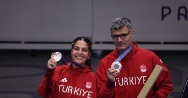 Turkish shooters Şevval Ilayda Tarhan and Yusuf Dikeç show off their 10-meter air pistol event silver medals at the 2024 Paris Olympics, Paris, France, July 30, 2024. (AA Photo)