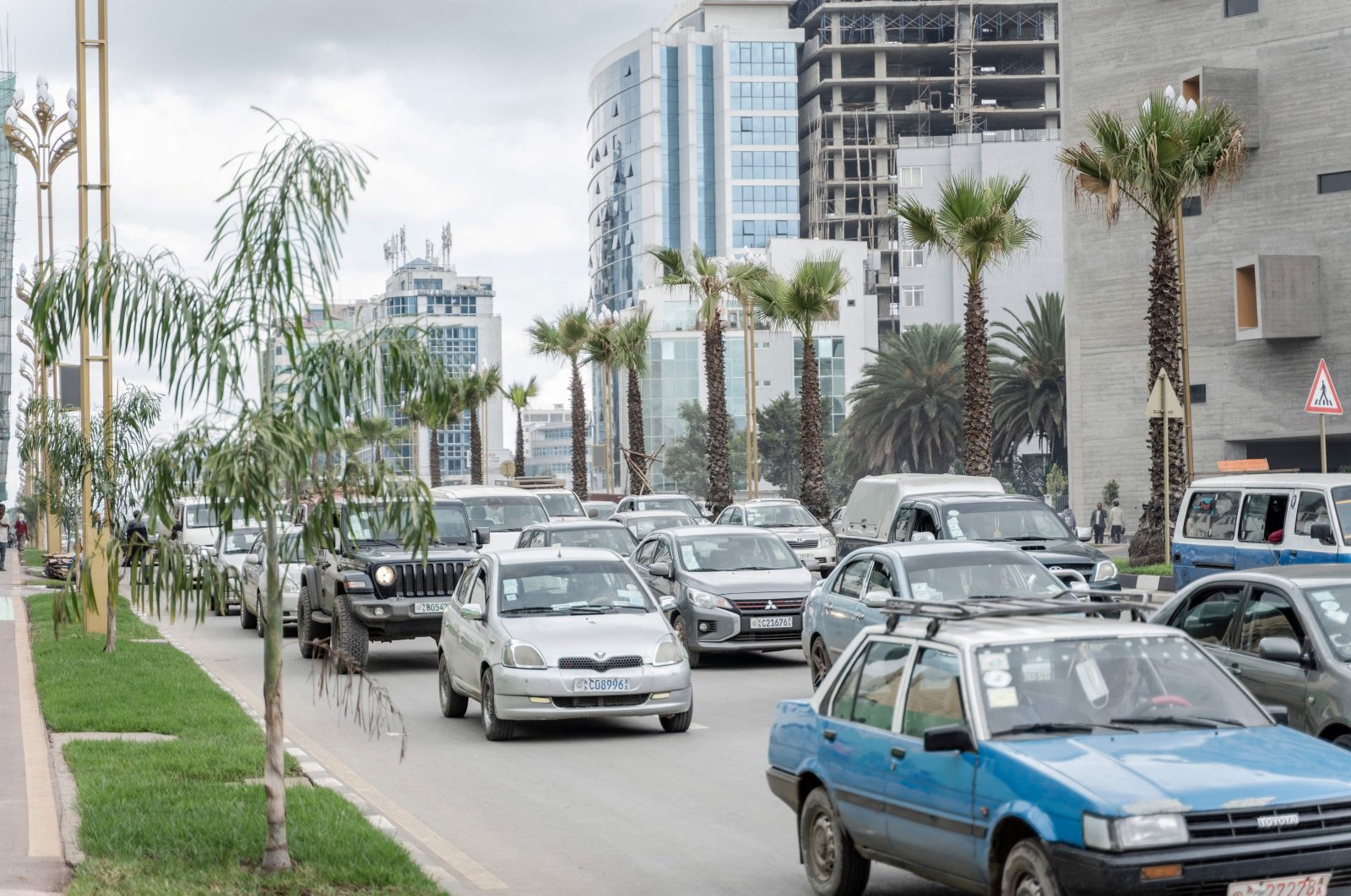 Cars drive past newly planted trees and light installations in Addis Ababa, Ethiopia, July 27, 2024. (AFP Photo)