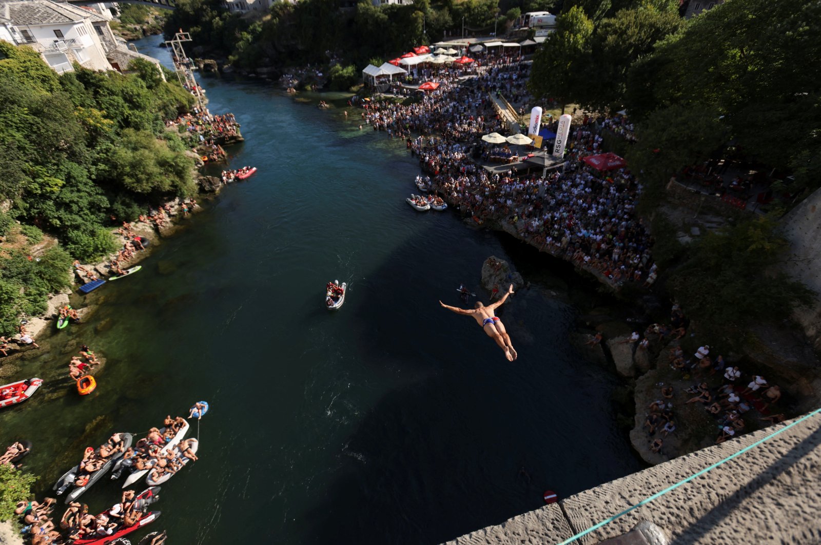 A high diver jumps from the arch of the Old Bridge during the 458th edition of the traditional diving competition in Mostar, Bosnia-Herzegovina, July 28, 2024. (Reuters Photo)