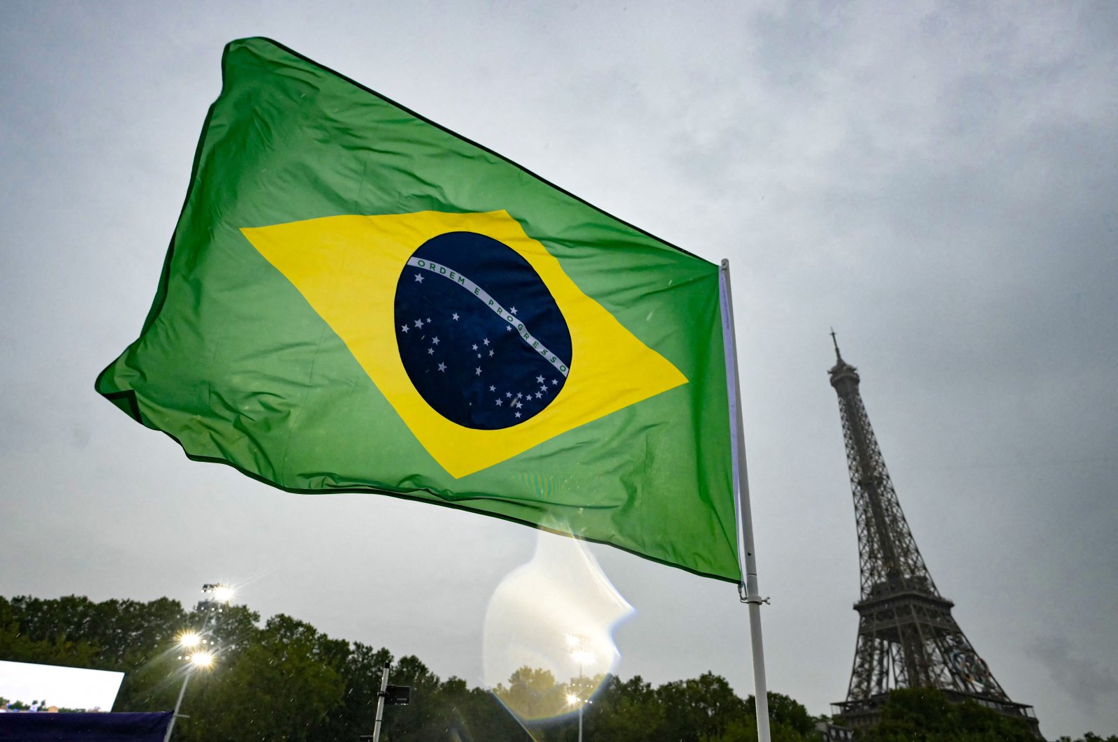 The flag of Brazil flutters below the Eiffel Tower on the boat of the athletes from Brazil&#039;s delegation along the river Seine during the opening ceremony of the Paris 2024 Olympics, Paris, France, July 26, 2024. (Reuters Photo)