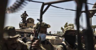 U.S.-backed PKK/YPG terrorists sit on their armored vehicles, in the town of al-Sabha in the eastern countryside of Deir el-Zour, Syria, Sept. 4, 2023. (AP Photo)