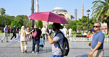 Tourists are seen on a hot summer day with a backdrop of Hagia Sophia Grand Mosque, Istanbul, Türkiye, July 19, 2024. (AA Photo)