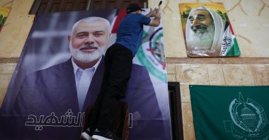 A man hangs a picture of Hamas leader Ismail Haniyeh at Burj al-Barajneh Palestinian refugee camp in Beirut, Lebanon, July 31, 2024. (Reuters Photo)