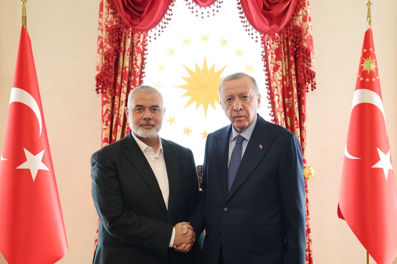 President Recep Tayyip Erdoğan (R) shakes hands with Ismail Haniyeh, the political leader of the Palestinian movement Hamas, at the Dolmabahce Presidential working office in Istanbul, Türkiye,  April 20, 2024. (AFP Photo)