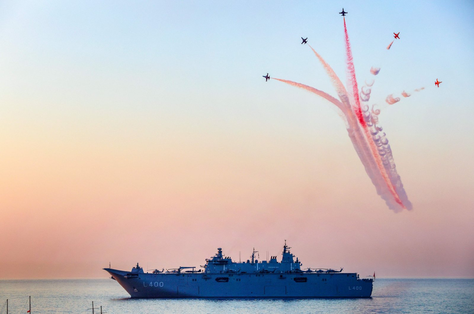 Turkish fighter jets fly over a battleship during a ceremony to mark 50 years of Türkiye&#039;s Cyprus Peace Operation in the city of Girne (Kyrenia), TRNC, July 20, 2024. (AFP Photo)