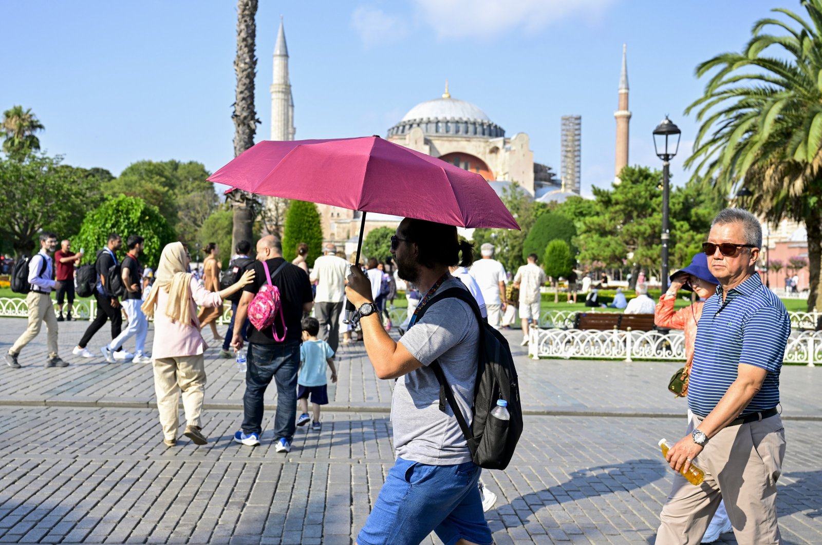 Tourists are seen on a hot summer day with a backdrop of Hagia Sophia Grand Mosque, Istanbul, Türkiye, July 19, 2024. (AA Photo)