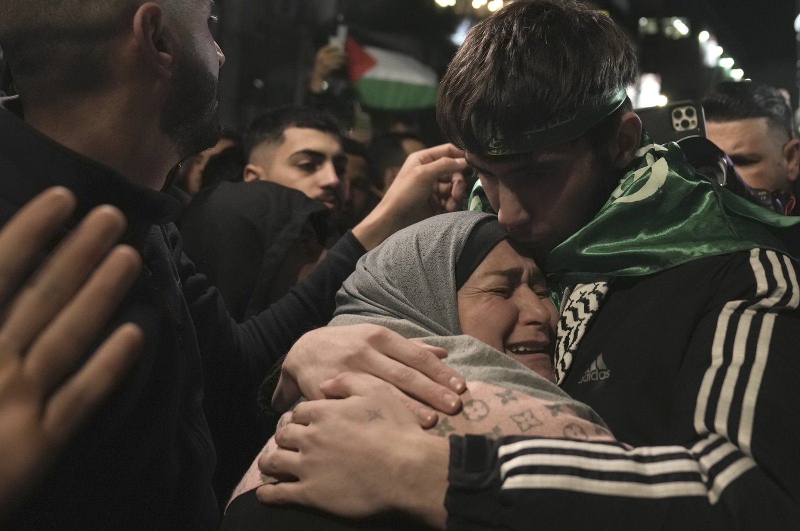 Omar Atshan, 17, is hugged by his mother after being released from an Israeli prison in the West Bank town of Ramallah, Palestine, Nov. 26, 2023.