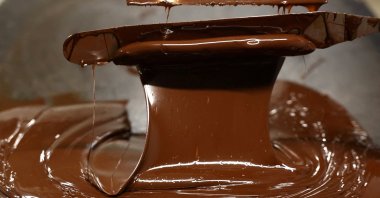 A worker cools chocolate during a manufacturing process in Belgium, May 15, 2024. (Reuters Photo)