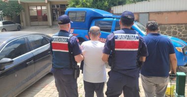 Gendarmerie officers escort a wanted FETÖ convict in northern Kocaeli province, Türkiye, July 26, 2024. (AA Photo)