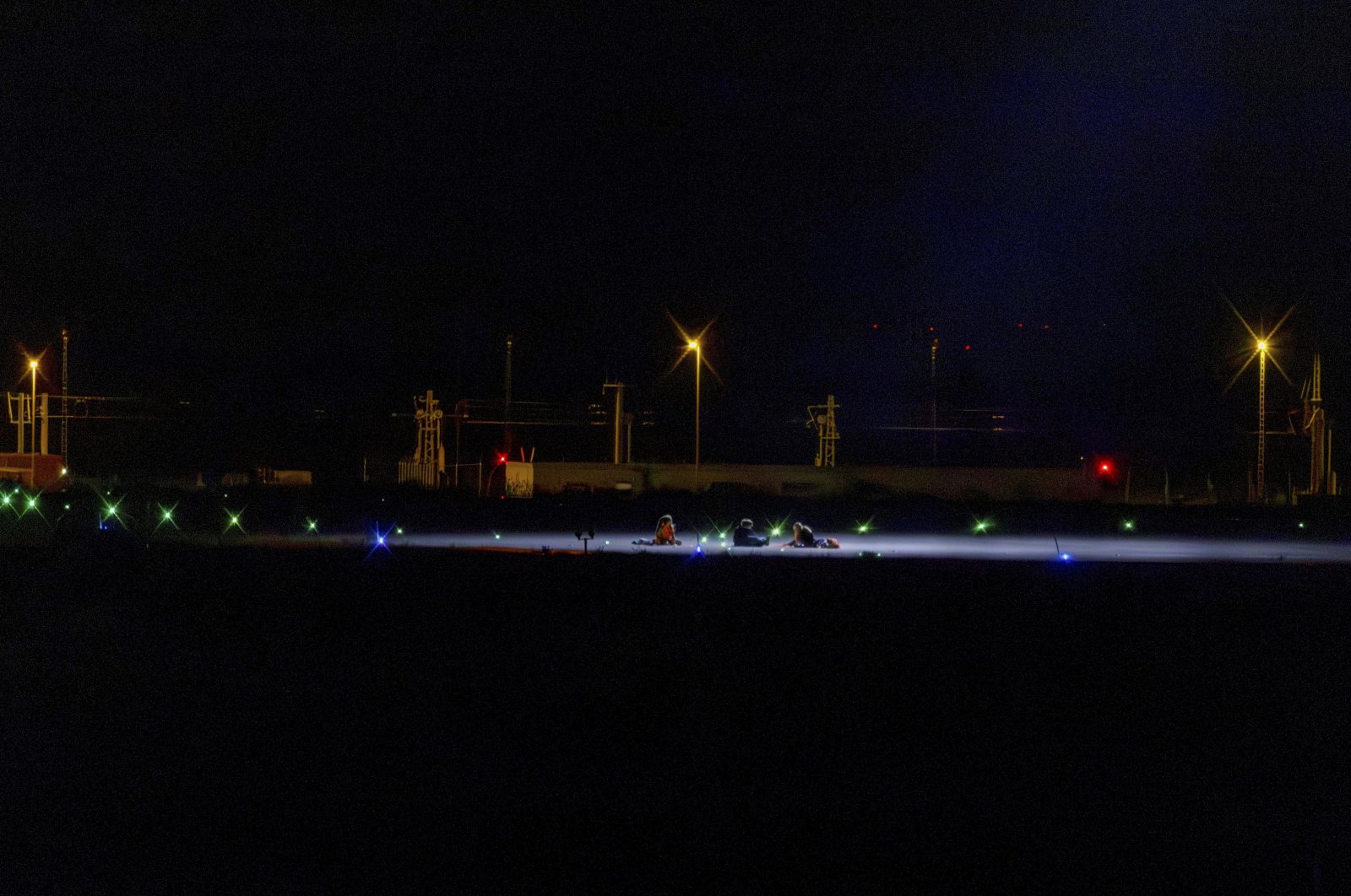 Climate activists sit on a tarmac at Leipzig-Halle Airport, Schkeuditz, Germany, Aug. 1, 2024. (AP Photo)