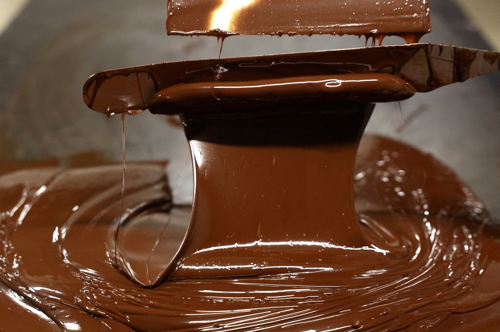 A worker cools chocolate during a manufacturing process in Belgium, May 15, 2024. (Reuters Photo)