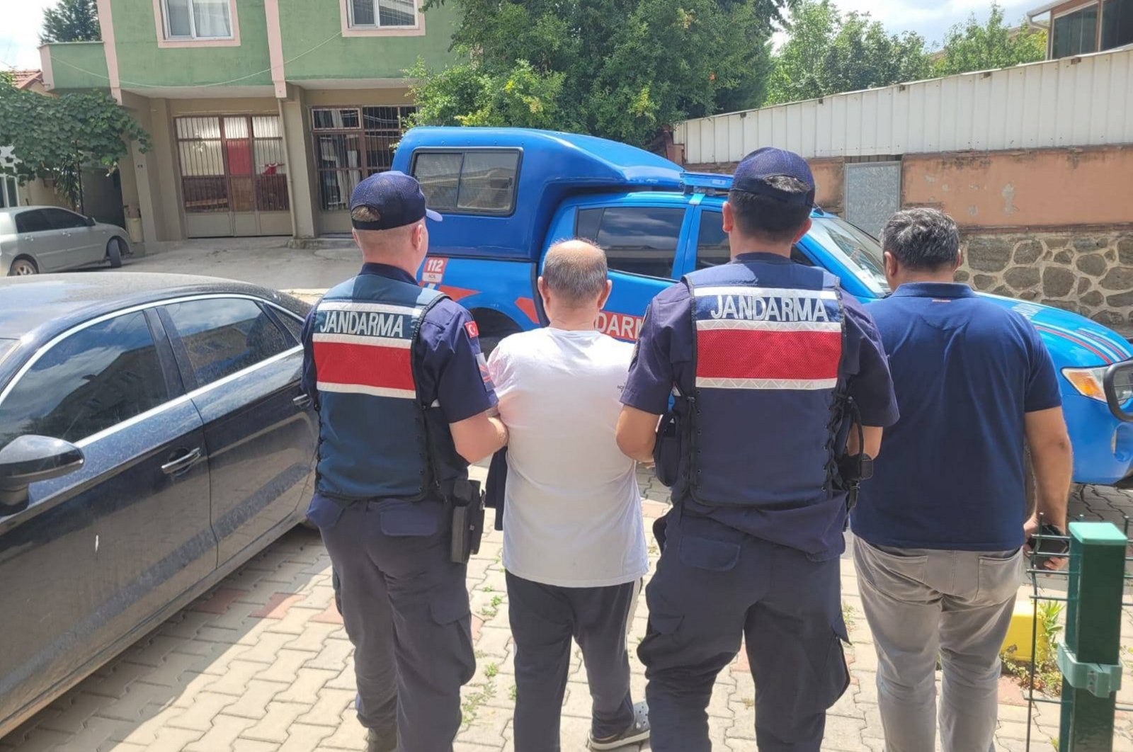 Gendarmerie officers escort a wanted FETÖ convict in northern Kocaeli province, Türkiye, July 26, 2024. (AA Photo)