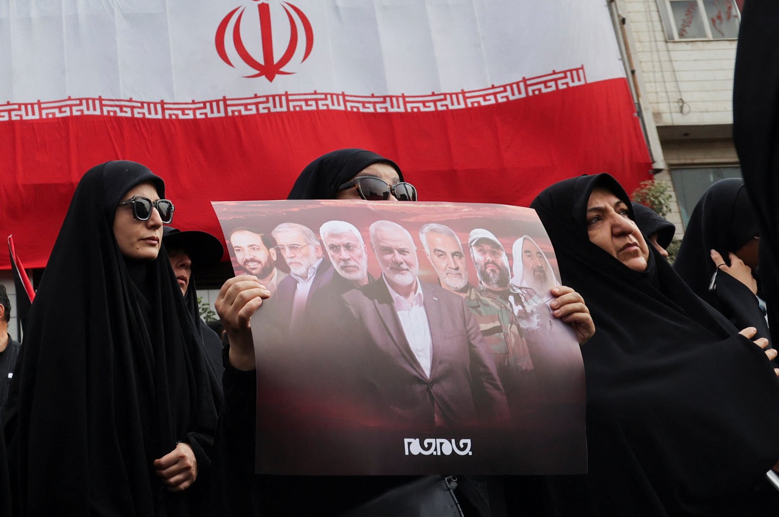 A woman holds a poster as she attends the funeral procession of assassinated Hamas chief Ismail Haniyeh, Tehran, Iran, Aug. 1, 2024. (Reuters Photo)