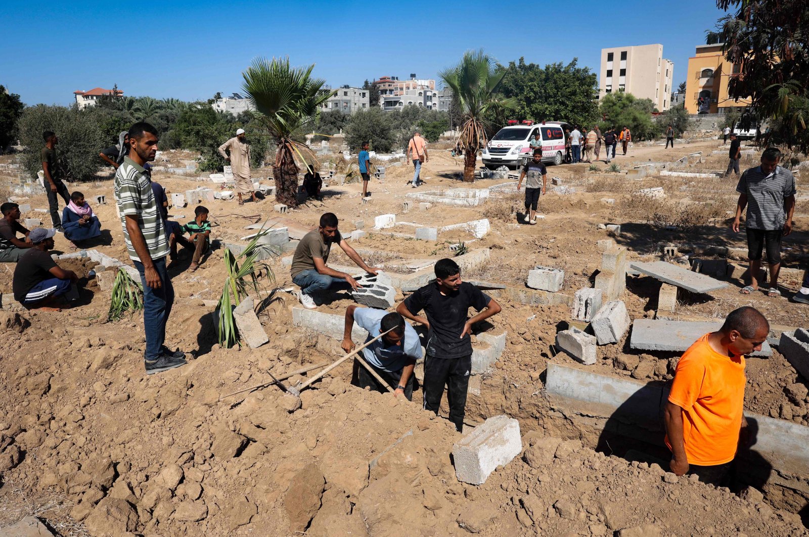 Palestinians dig graves at the al-Zawaida Cemetery, after the Israeli bombardment of the al-Bureij refugee Camp, in the central Gaza Strip, Palestine, July 31, 2024. (AFP Photo)