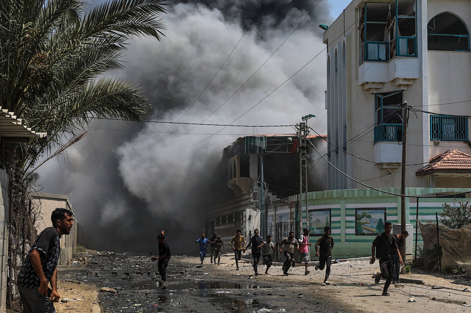 Internally displaced Palestinians run for cover following an Israeli attack, Gaza Strip, Palestine, July 27, 2024. (EPA Photo)