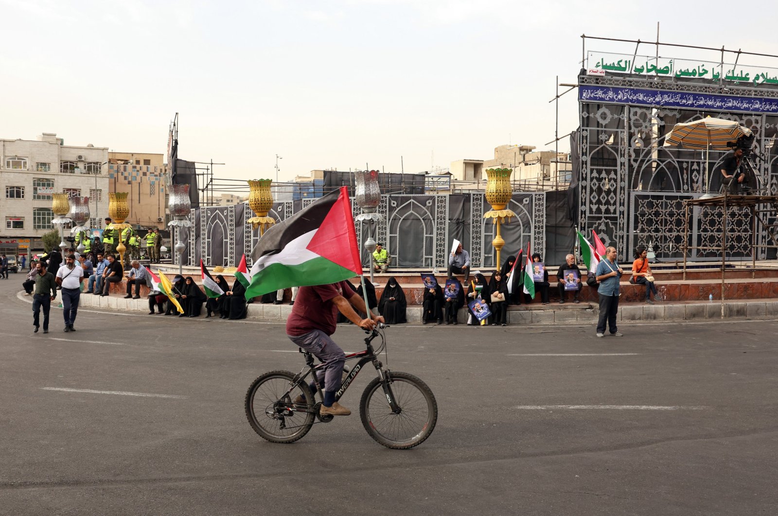 A person rides a bicycle while waving a Palestinian flag during a funeral procession (not pictured) for Hamas late political leader Ismail Haniyeh, Tehran, Iran, Aug. 1, 2024. (EPA Photo)