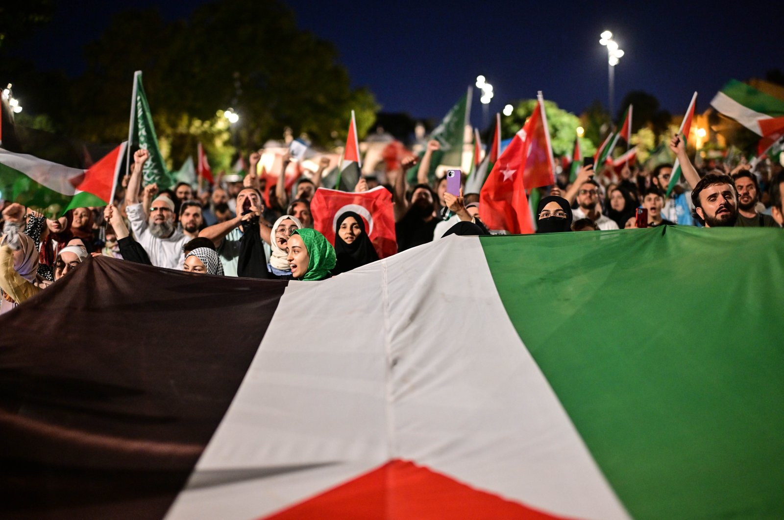 Demonstrators wave Palestinian and Turkish flags as they take part in a rally to protest the death of the Hamas leader Ismail Haniyeh, in the Fatih district of Istanbul, Türkiye, July 31, 2024. (AA Photo)