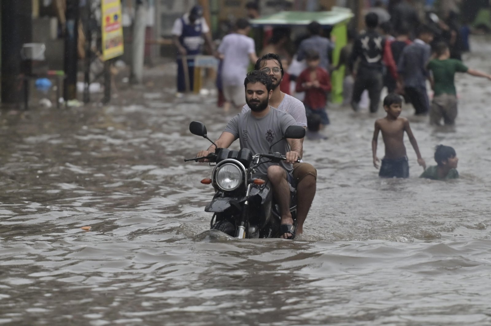 People make their way through a flooded street after heavy rainfall, Lahore, Pakistan, July 28, 2024. (EPA Photo)