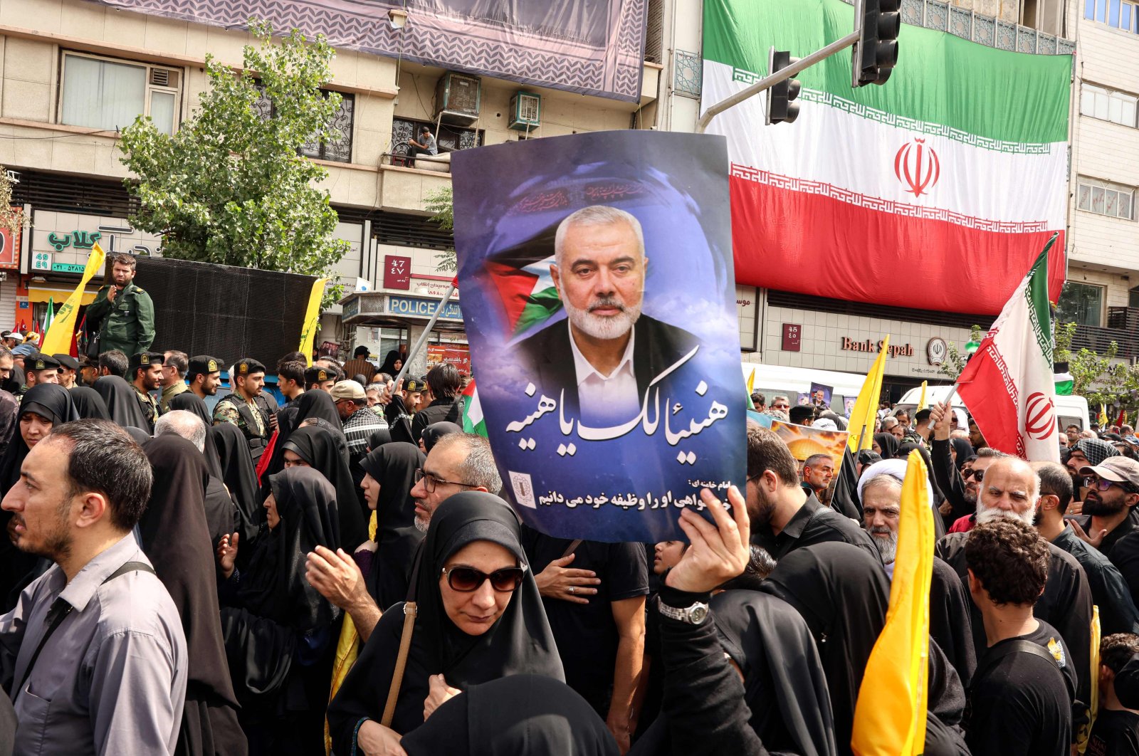 Iranians hold portraits of late Hamas leader Ismail Haniyeh during his funeral procession ahead of his burial in Qatar, Tehran, Iran, Aug. 1, 2024. (AFP Photo)