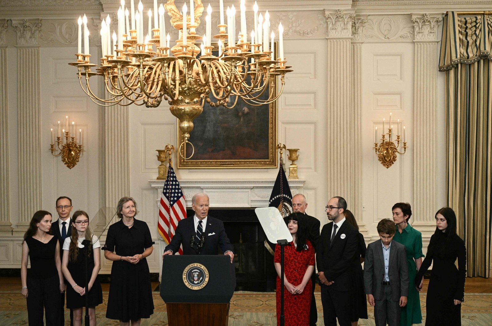 U.S. President Joe Biden, standing alongside family members of the freed prisoners, speaks about the prisoner exchange with Russia, in the State Dining Room of the White House in Washington, D.C., Aug. 1, 2024. (AFP Photo)