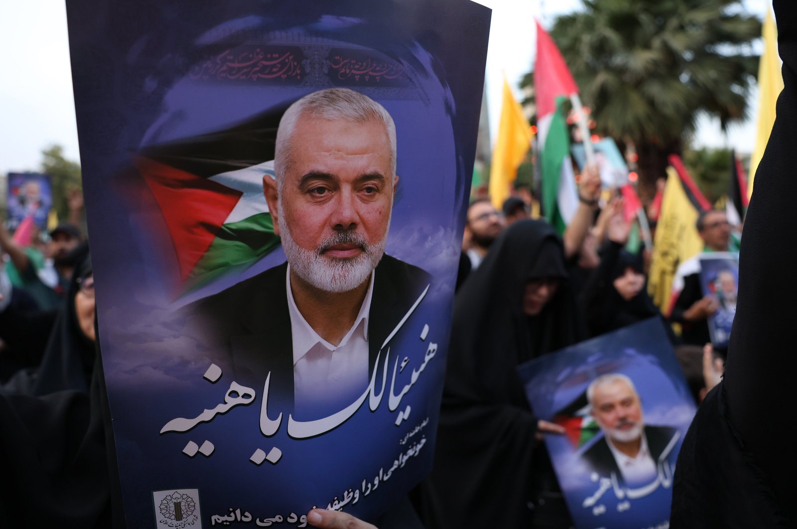 Iranians hold pictures of late Hamas political chief Ismail Haniyeh during a protest at the Palestine Square in Tehran, Iran, July 31, 2024. (EPA Photo)