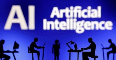Figurines with computers and smartphones are seen in front of the words &quot;Artificial Intelligence AI&quot; in this illustration taken Feb. 19, 2024. (Reuters Photo)