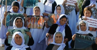 Yazidi women raise banners during a demonstration demanding their rights and the release of those kidnapped by Daesh militants, Mosul, Iraq, June 3, 2024. (Reuters Photo)