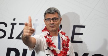 Turkish shooter Yusuf Dikeç poses for a photo on his arrival at the Esenboğa Airport, Ankara, Türkiye, Aug. 1, 2024. (AA Photo)