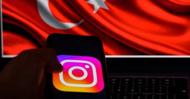 This picture taken in Istanbul shows the logo of the social network Instagram on a smartphone with the Turkish flag in the background, Türkiye, Aug. 2, 2024. (AFP Photo)