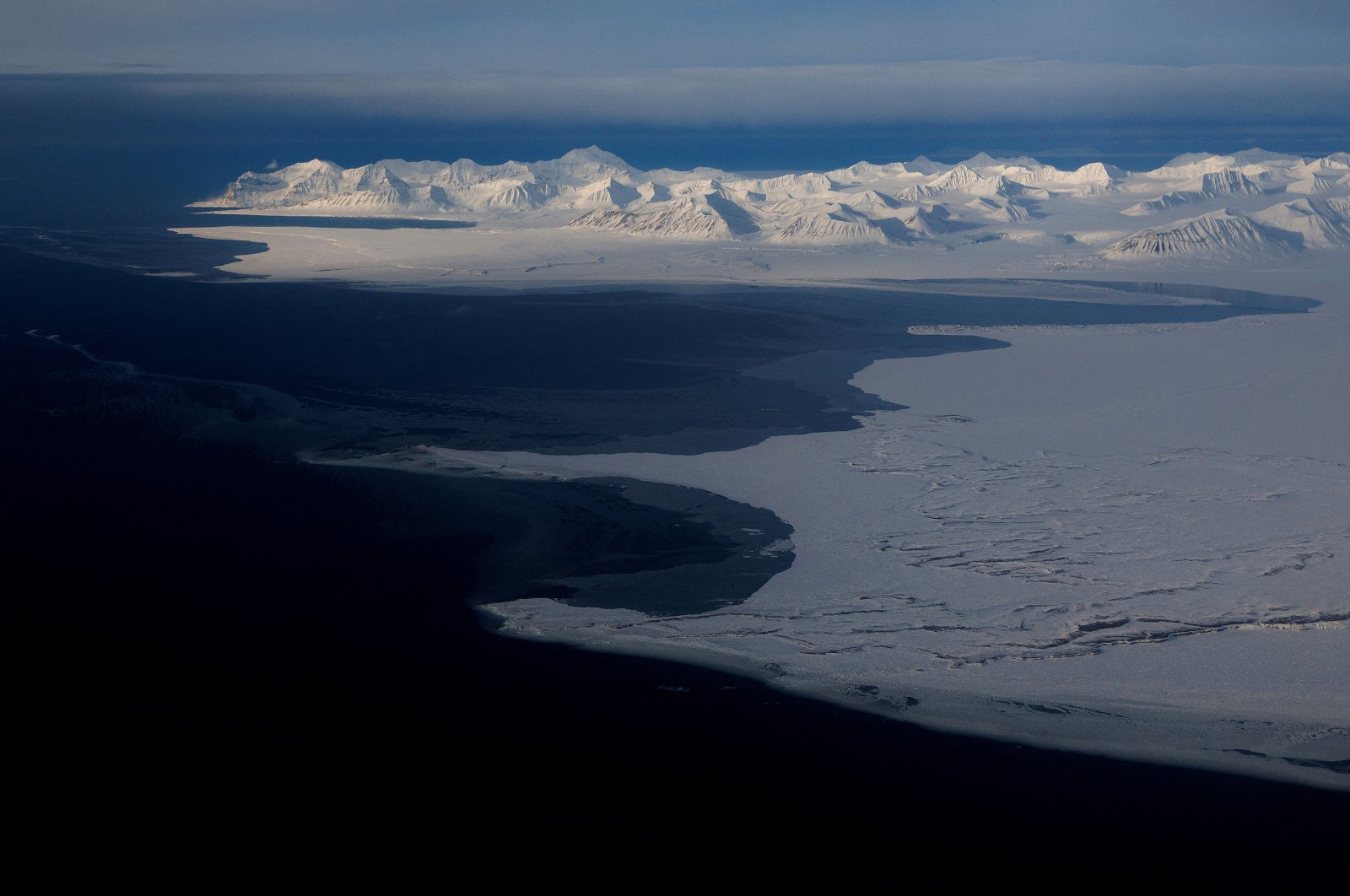 A general view of snowcapped mountains and the Arctic Ocean on the coast of Svalbard near Longyearbyen, Norway, April 5, 2023. (Reuters Photo)