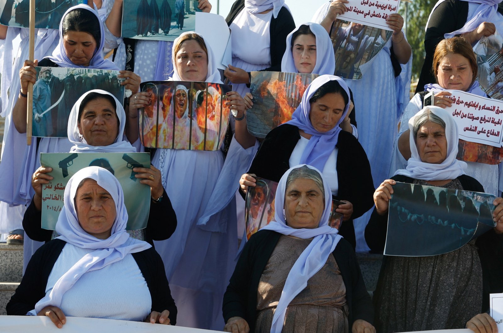 Yazidi women raise banners during a demonstration demanding their rights and the release of those kidnapped by Daesh militants, Mosul, Iraq, June 3, 2024. (Reuters Photo)