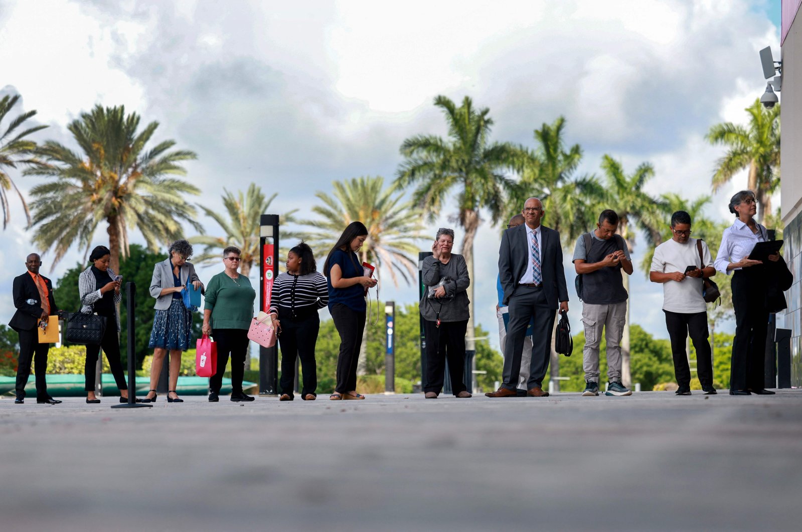 People line up as they wait for the JobNewsUSA.com South Florida Job Fair to open at the Amerant Bank Arena in Sunrise, Florida, U.S., June 26, 2024. (AFP Photo)