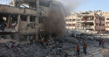 Palestinian rescuers extinguish a fire at a destroyed building following Israeli bombardment which hit a school complex, in the Sheikh Radwan neighborhood, north of Gaza City, Palestine, Aug. 3, 2024. (AFP Photo)