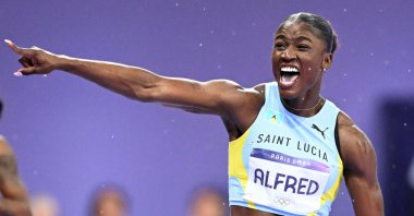 St. Lucia's Julien Alfred celebrates winning the women's 100m final at the Paris 2024 Olympic Games, Stade de France, Paris, France, Aug. 3, 2024. (AFP Photo)