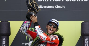 Ducati Lenovo Team&#039;s Enea Bastianini celebrates with the trophy on the podium after winning the British Grand Prix, Silverstone, U.K., Aug. 4, 2024.