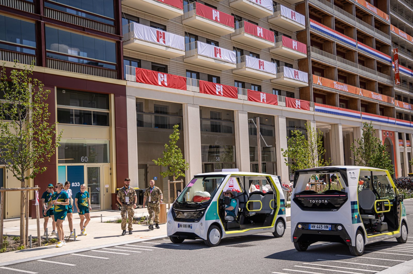 Electric shuttles drive at the Athletes&#039; Village of the Paris 2024 Olympic Games in Saint Denis, France, July 18, 2024. (EPA Photo)