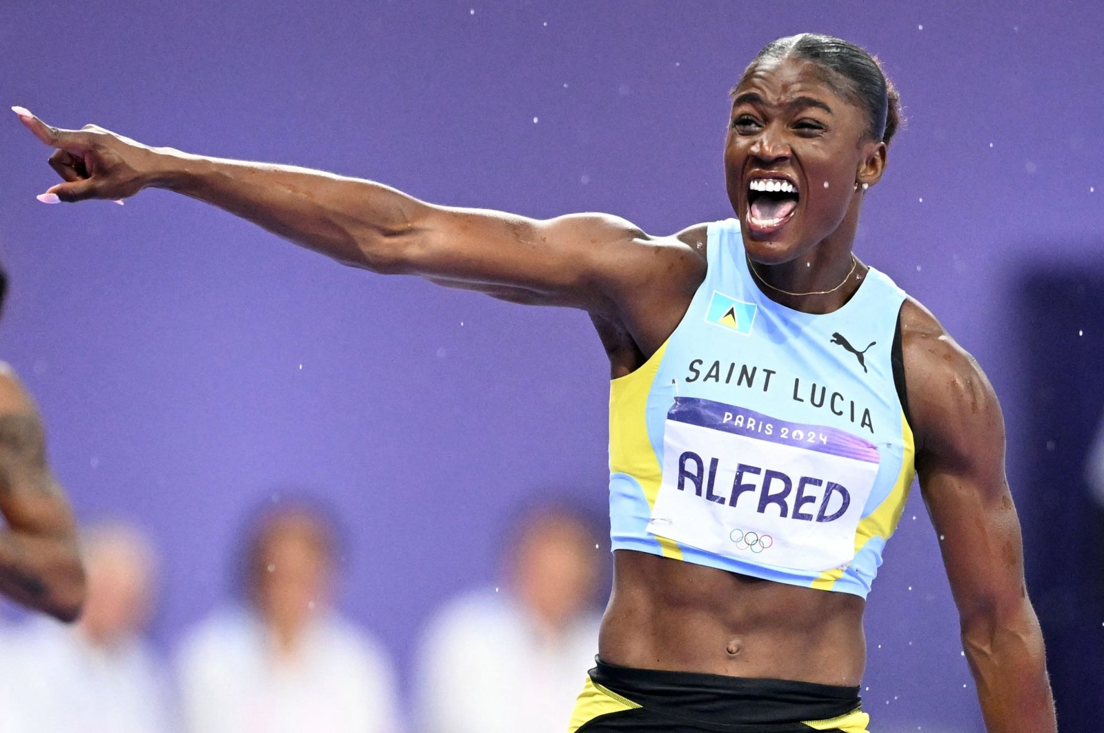 St. Lucia&#039;s Julien Alfred celebrates winning the women&#039;s 100m final at the Paris 2024 Olympic Games, Stade de France, Paris, France, Aug. 3, 2024. (AFP Photo)