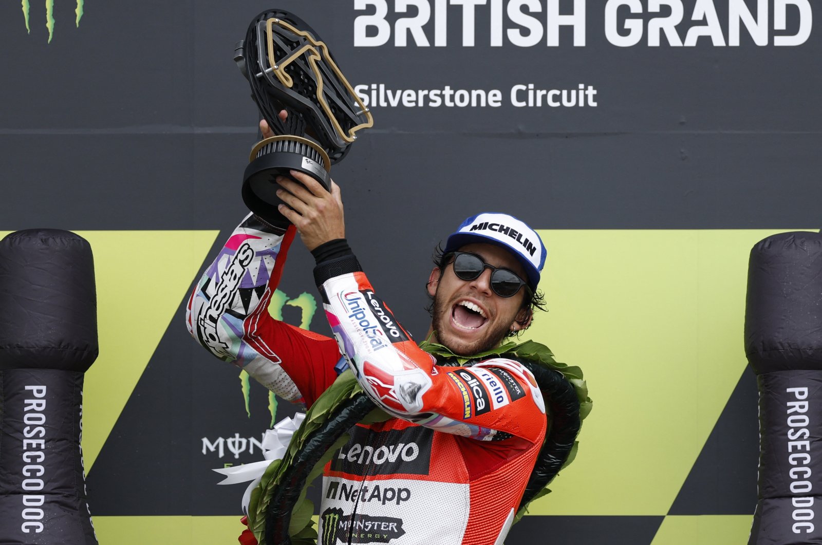 Ducati Lenovo Team&#039;s Enea Bastianini celebrates with the trophy on the podium after winning the British Grand Prix, Silverstone, U.K., Aug. 4, 2024.