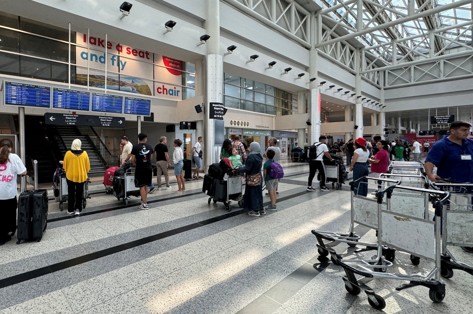 People stand near their luggage at the Beirut-Rafic Al Hariri International Airport, in Beirut, Lebanon, Aug. 4, 2024. (Reuters Photo)