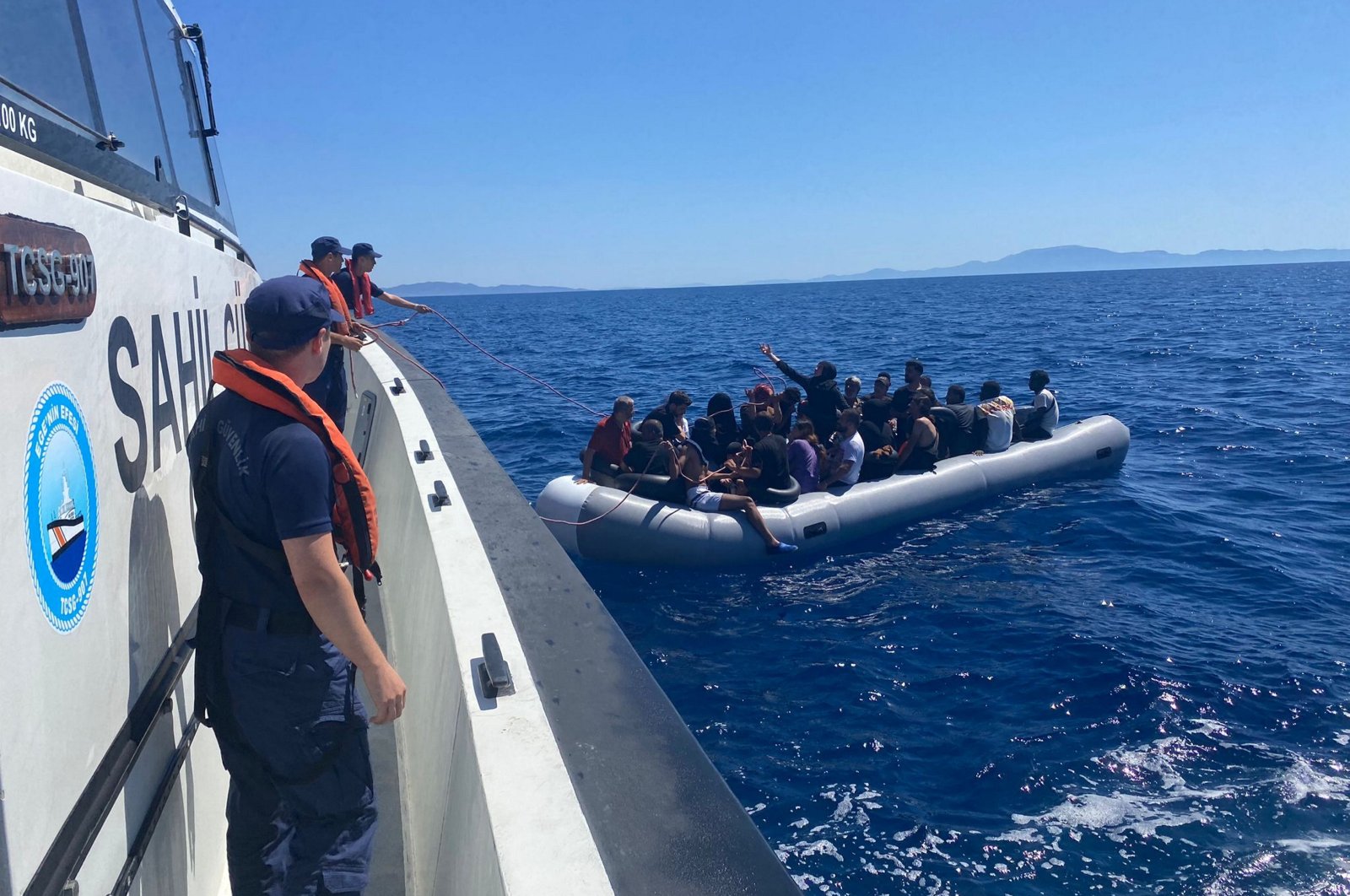 Turkish coast guard vessel picks up a rubber boat carrying 23 migrants pushed back by Greece off the coast of western Izmir province, Türkiye, July 5, 2024. (AA Photo)