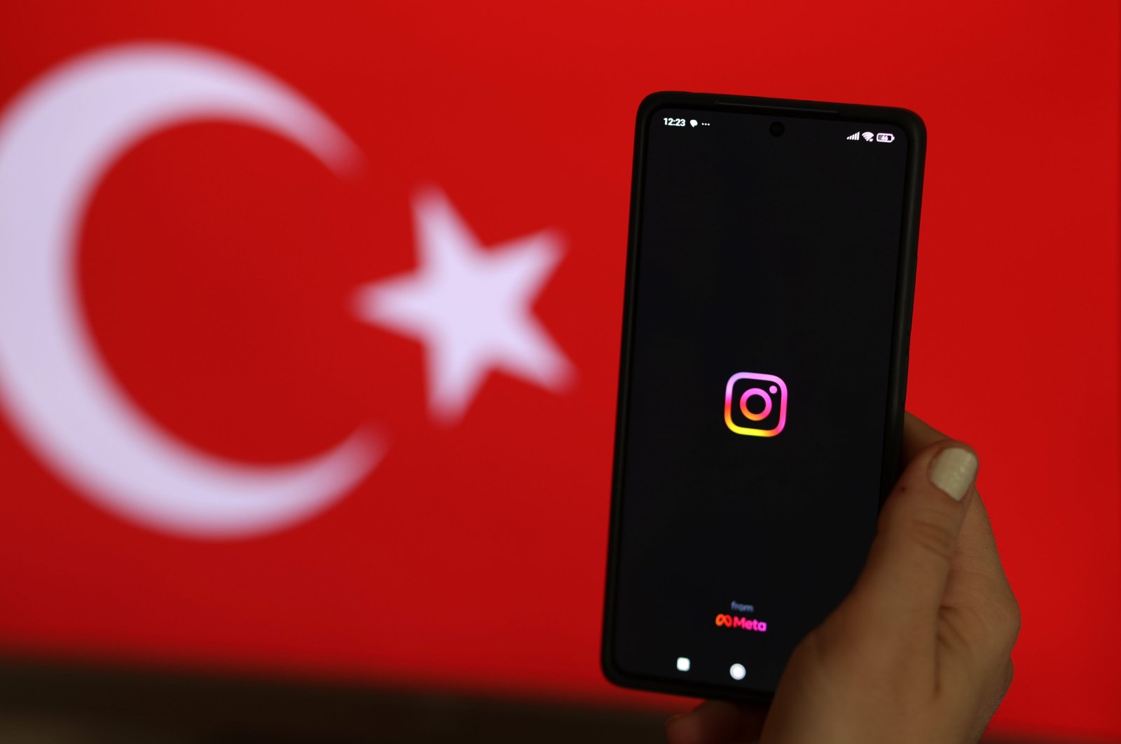 A woman holds a phone showing the Instagram logo, Istanbul, Türkiye, Aug. 3, 2024. (EPA Photo)