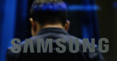 A man walks past a Samsung logo displayed at the company's Seocho building in Seoul, South Korea, July 31, 2024. (AFP Photo)