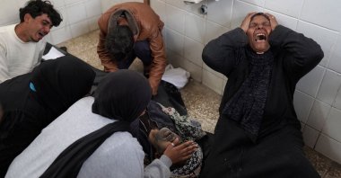 Relatives mourn over the dead body of a Palestinian man killed in Israeli airstrikes at the Al-Aqsa Martyrs Hospital in Deir al-Balah, central Gaza Strip, March 28, 2024. (AFP Photo)