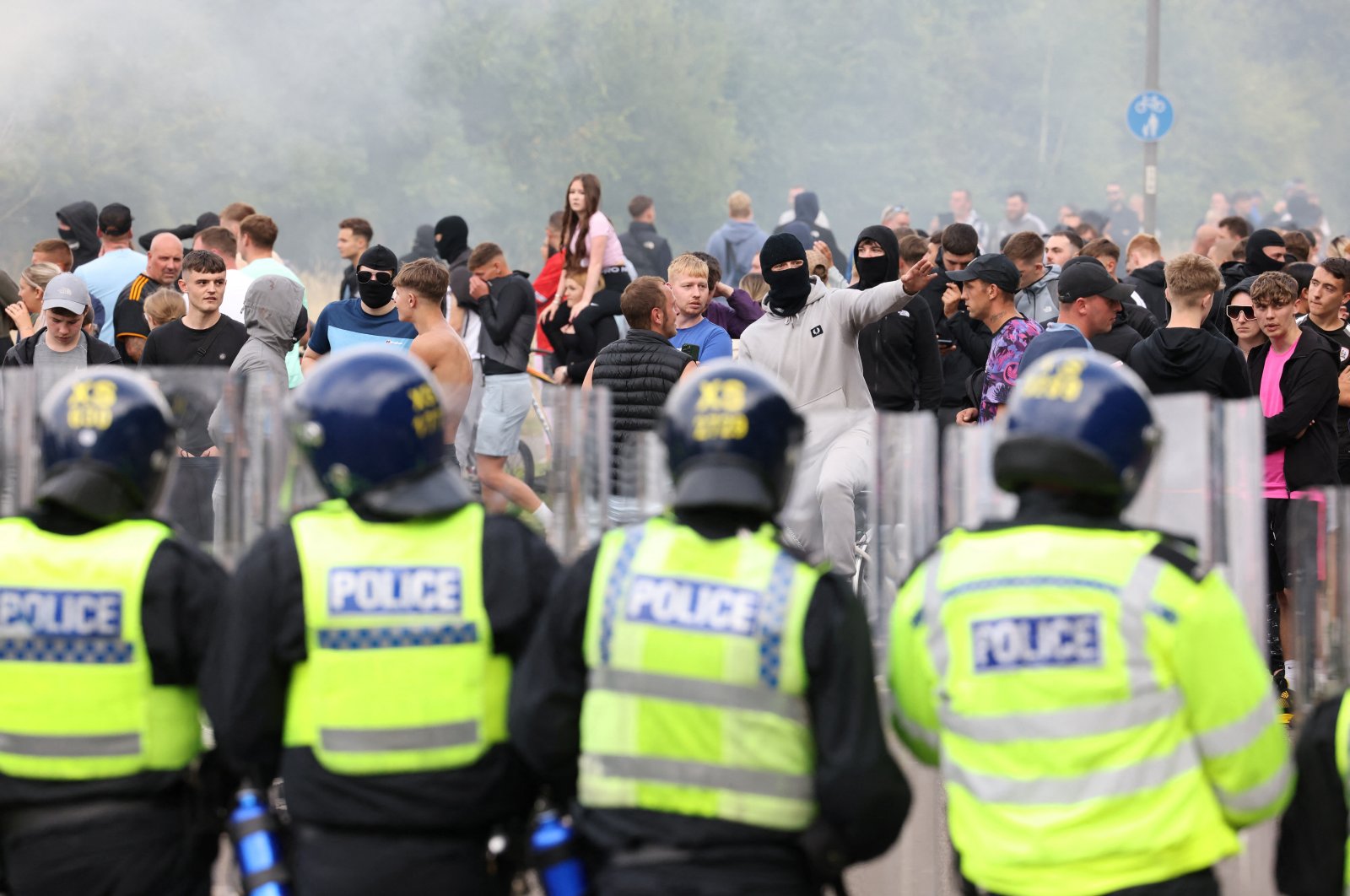 Police officers stand opposite to demonstrators during an anti-immigration, anti-Muslim protest, Rotherham, Britain, Aug 4, 2024. (Reuters Photo)