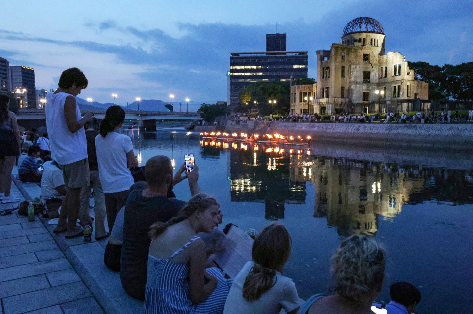 People light lanterns by the Motoyasu River in Hiroshima to mark the 79th anniversary of the first atomic bomb attack, Hiroshima, Japan, Aug. 5, 2024. (AFP Photo)