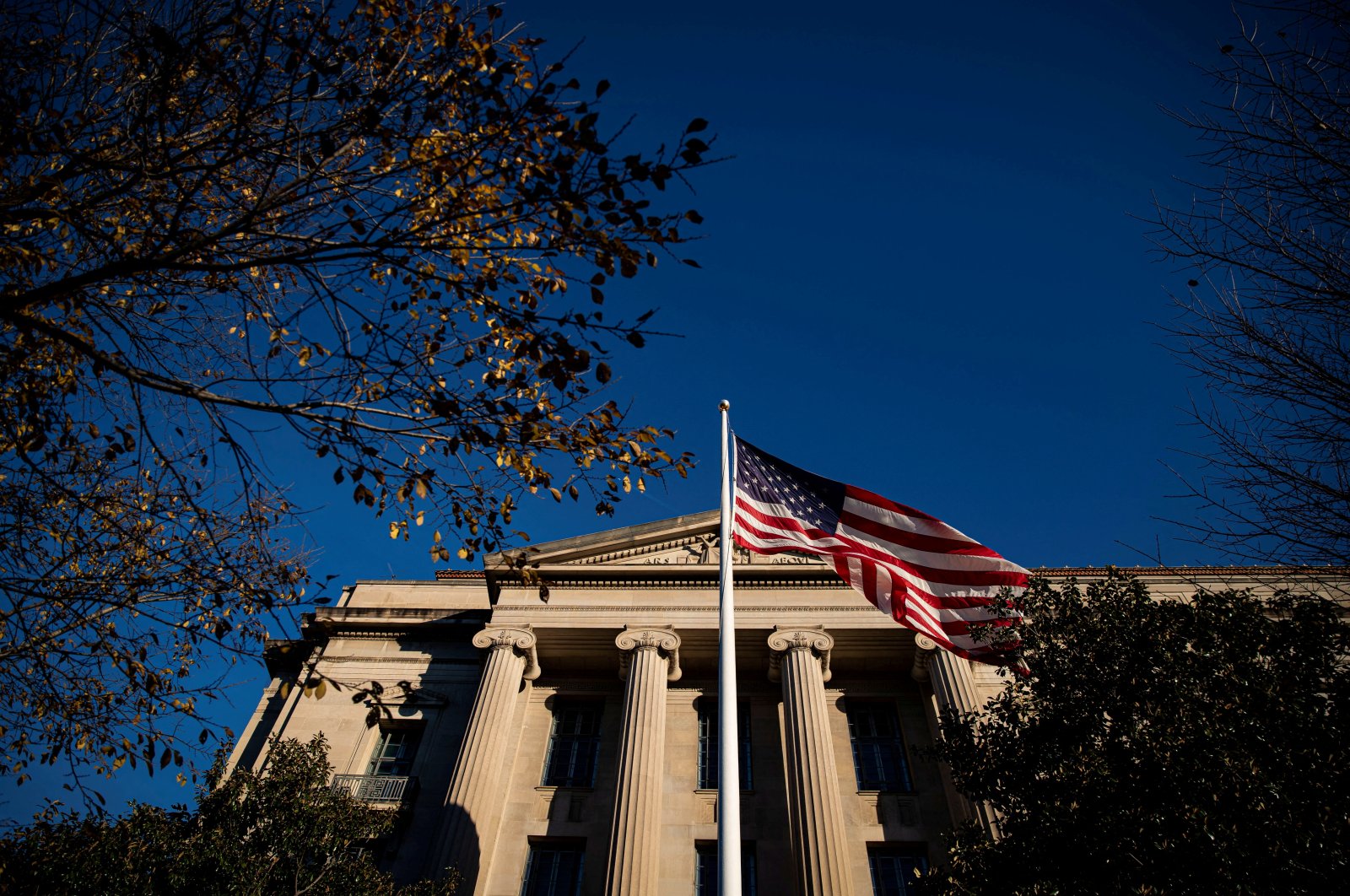 An American flag waves outside the U.S. Department of Justice Building in Washington, U.S., Dec. 15, 2020. (Reuters File Photo)