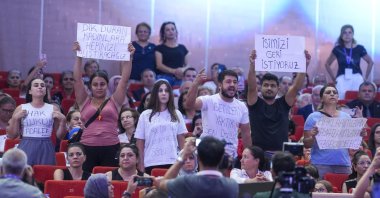 Fired workers wave placards reading "we want our jobs back" during an event attended by CHP leader Özgür Özel, Ankara, Türkiye, Aug. 4, 2024. (AA Photo)